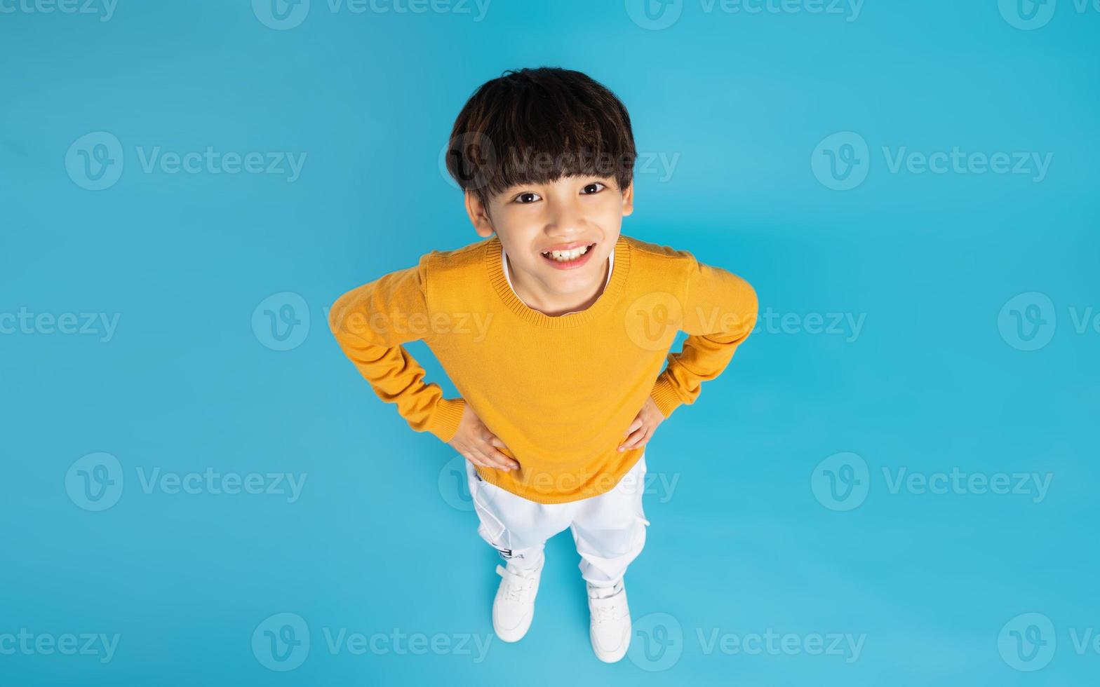 Asian boy portrait posing on blue background photo