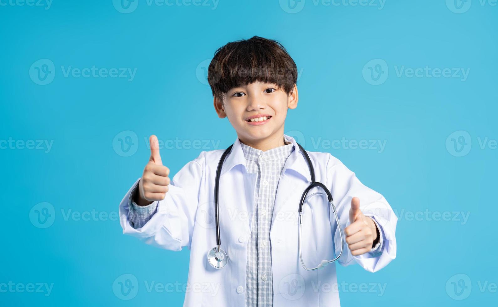 Asian boy portrait posing on blue background photo