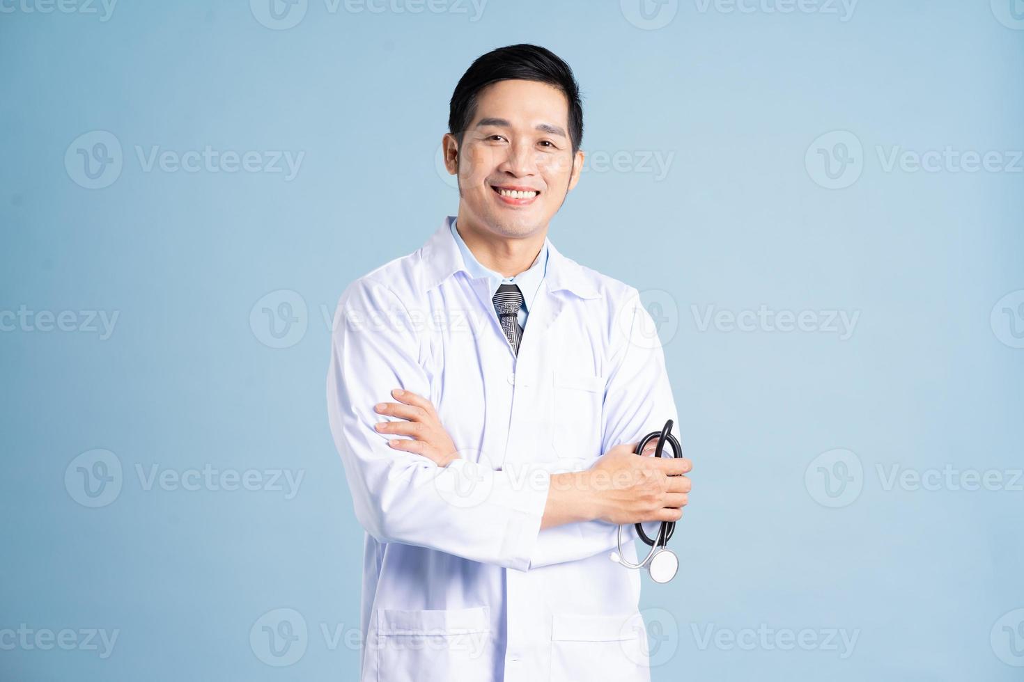 Asian male doctor portrait on blue background photo