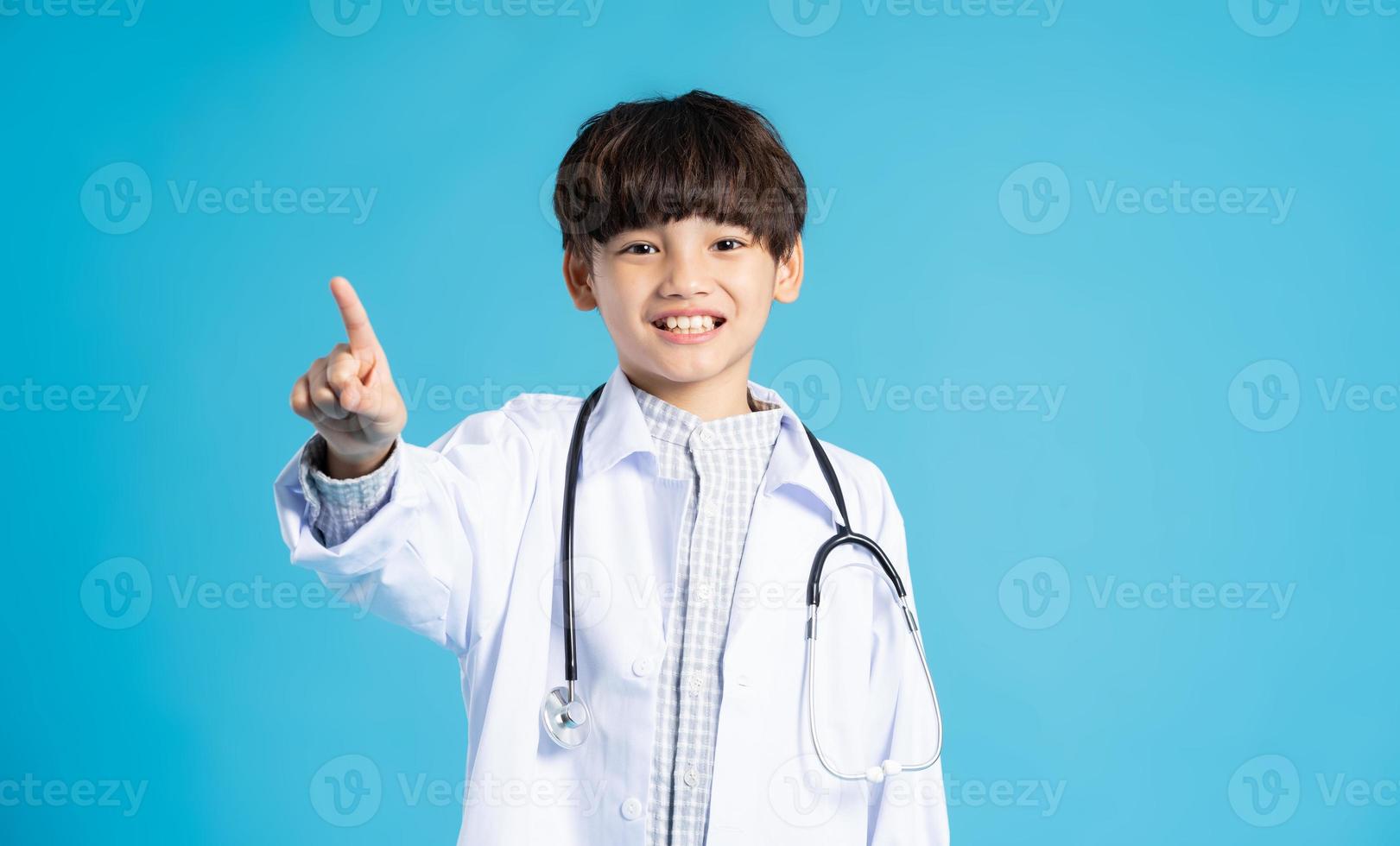 Asian boy portrait posing on blue background photo