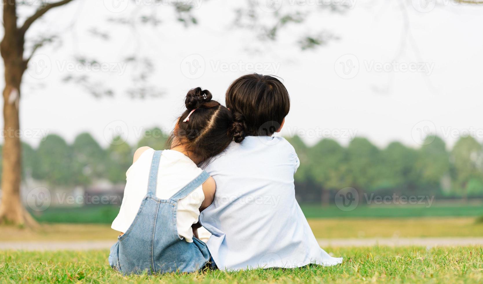 image of brother and sister having fun in the park photo