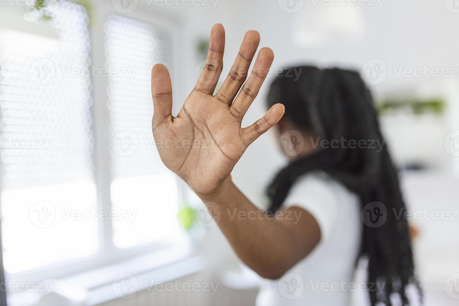 woman raised her hand for dissuade, campaign stop violence against women. African American woman raised her hand for dissuade with copy space photo
