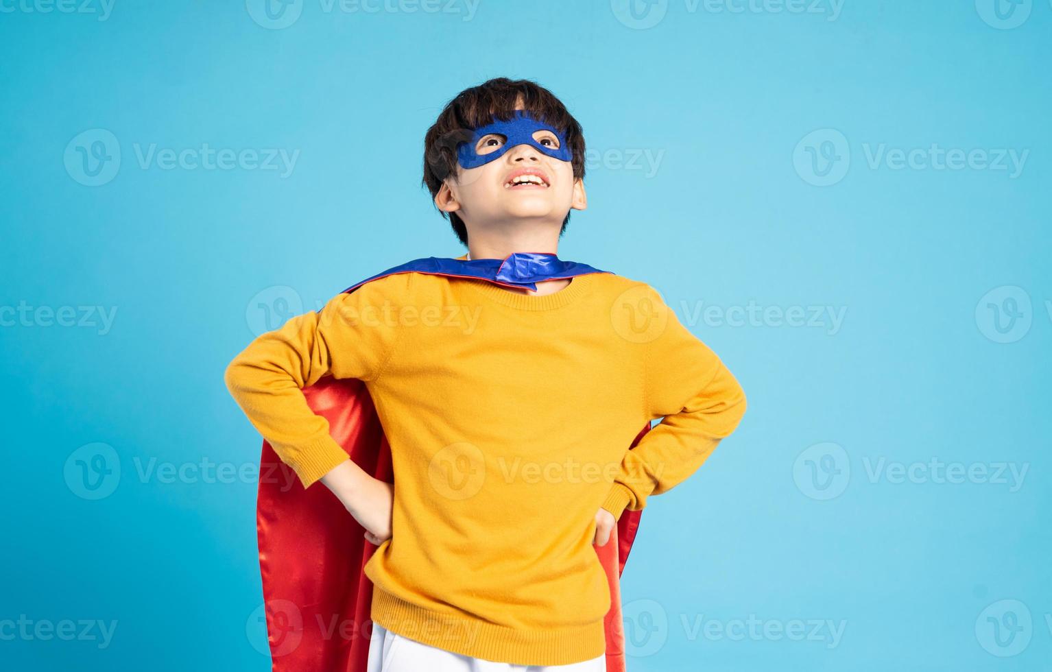 The image of a boy wearing a cape transforms into a hero photo