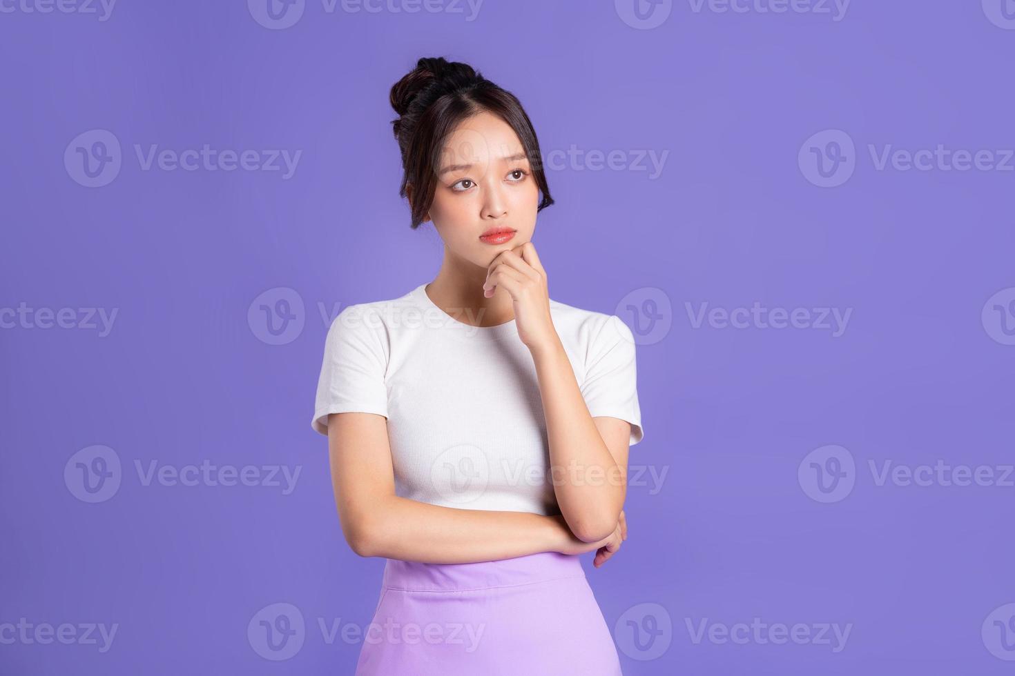 Portrait of a beautiful Asian woman posing on a purple background photo