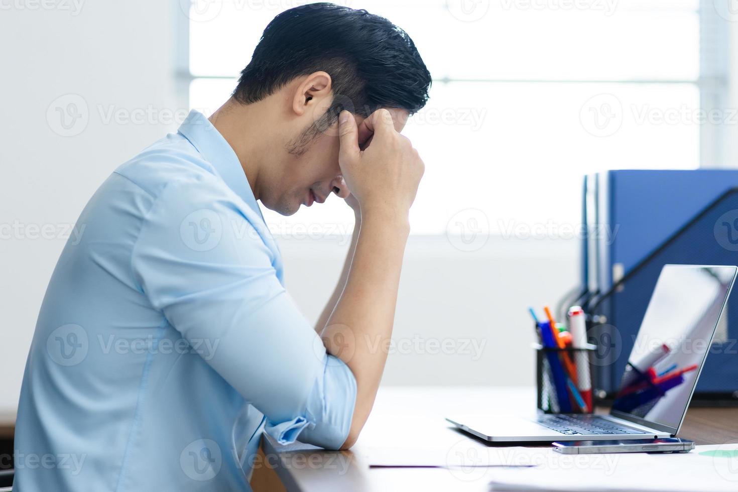 Asian businessman male portrait sitting at his desk photo