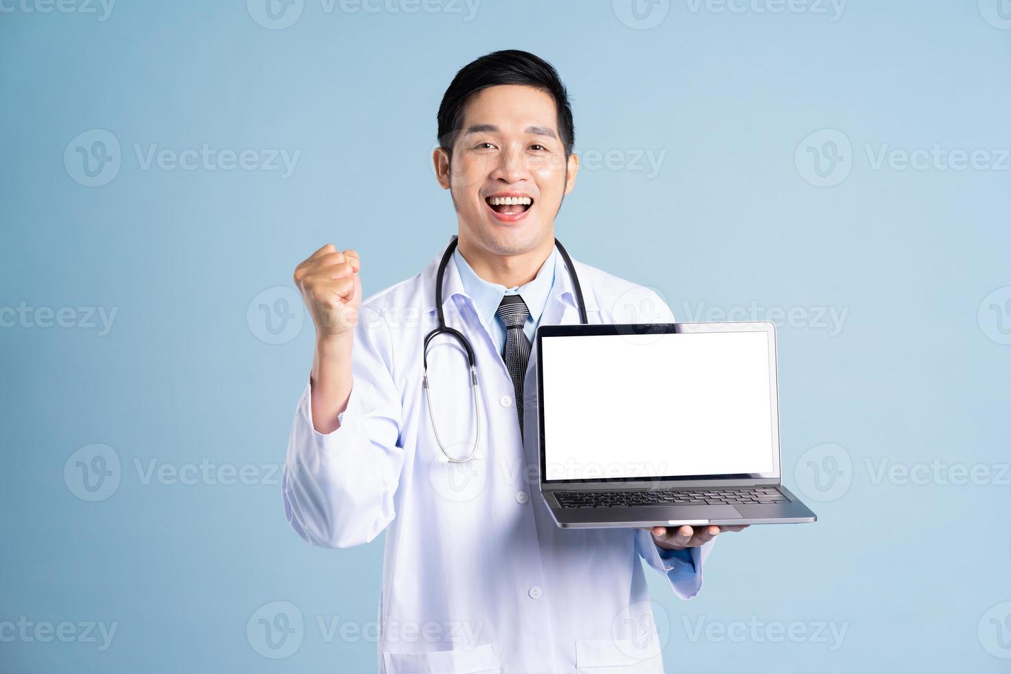 Asian male doctor portrait on blue background photo