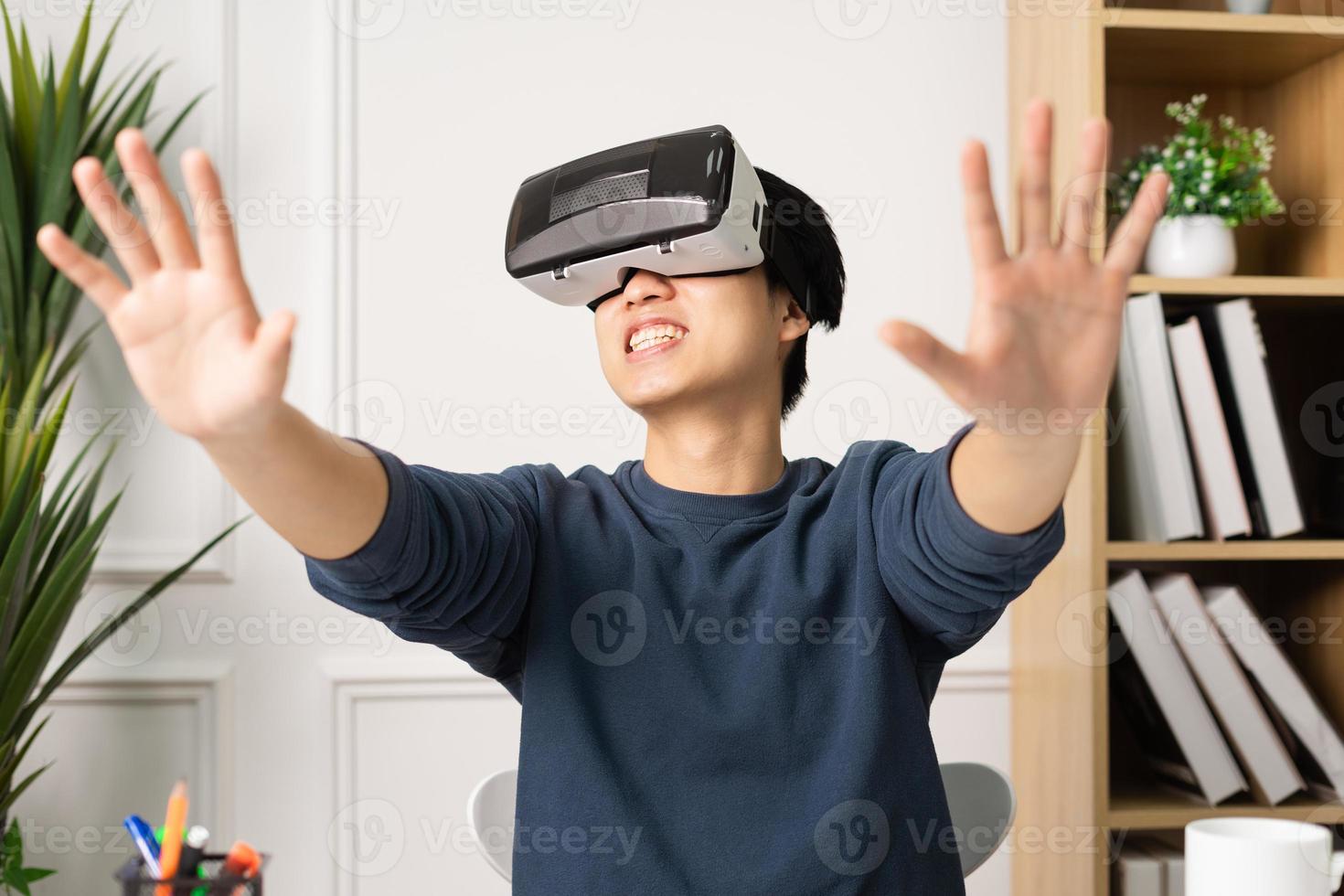 portrait of asian man using virtual reality glasses photo