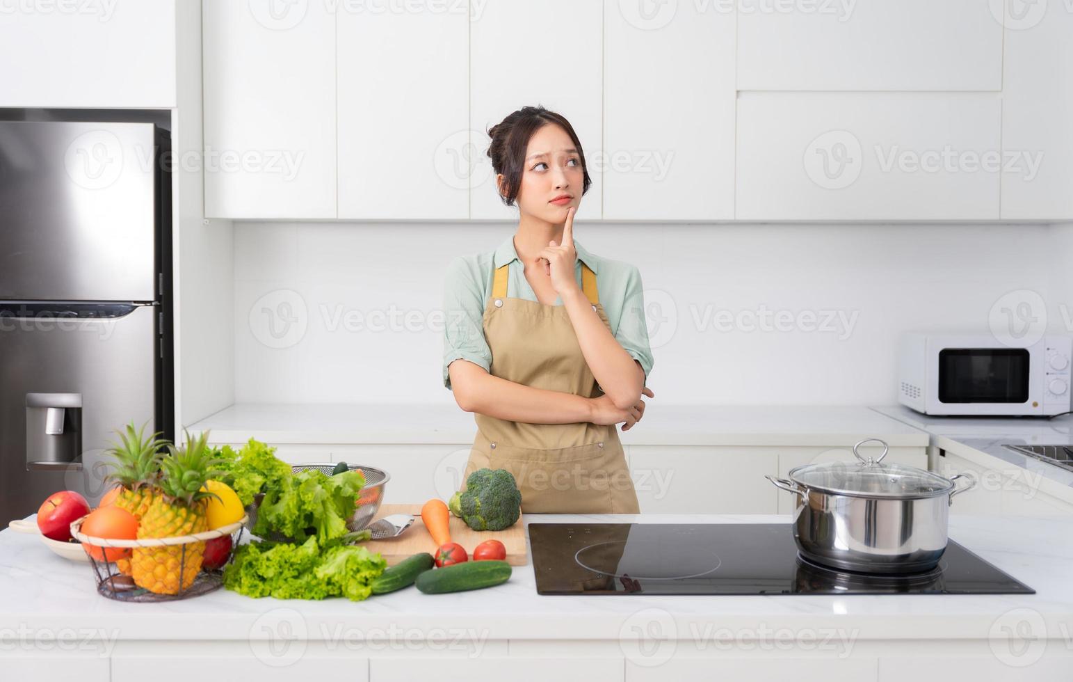 Portrait of a housewife in the kitchen at home photo