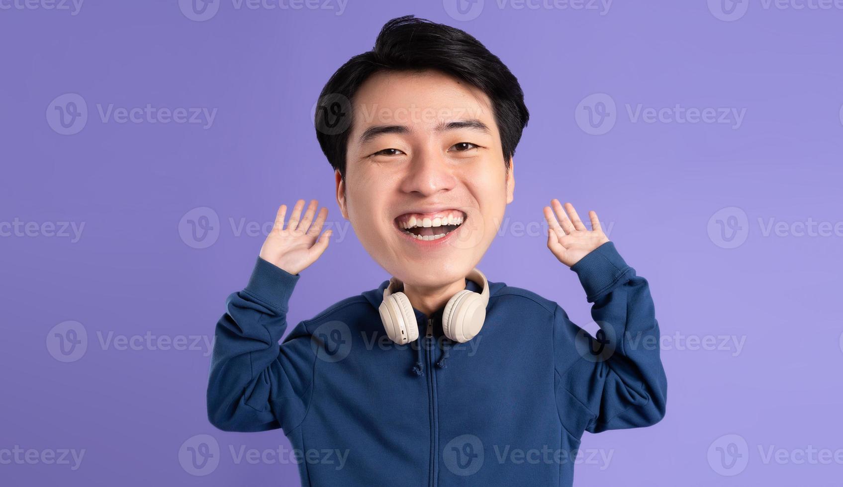 portrait of asian man posing on purple background photo