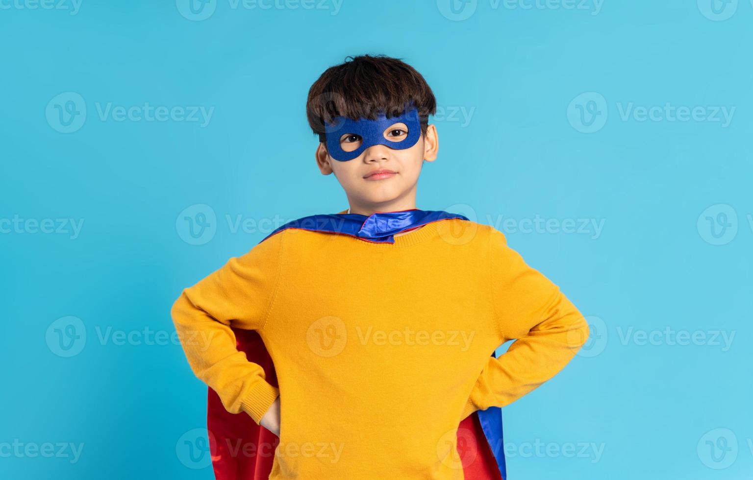 The image of a boy wearing a cape transforms into a hero photo