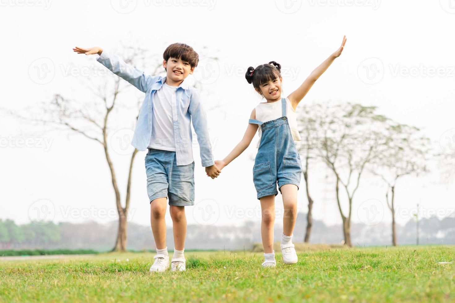 image of brother and sister having fun in the park photo