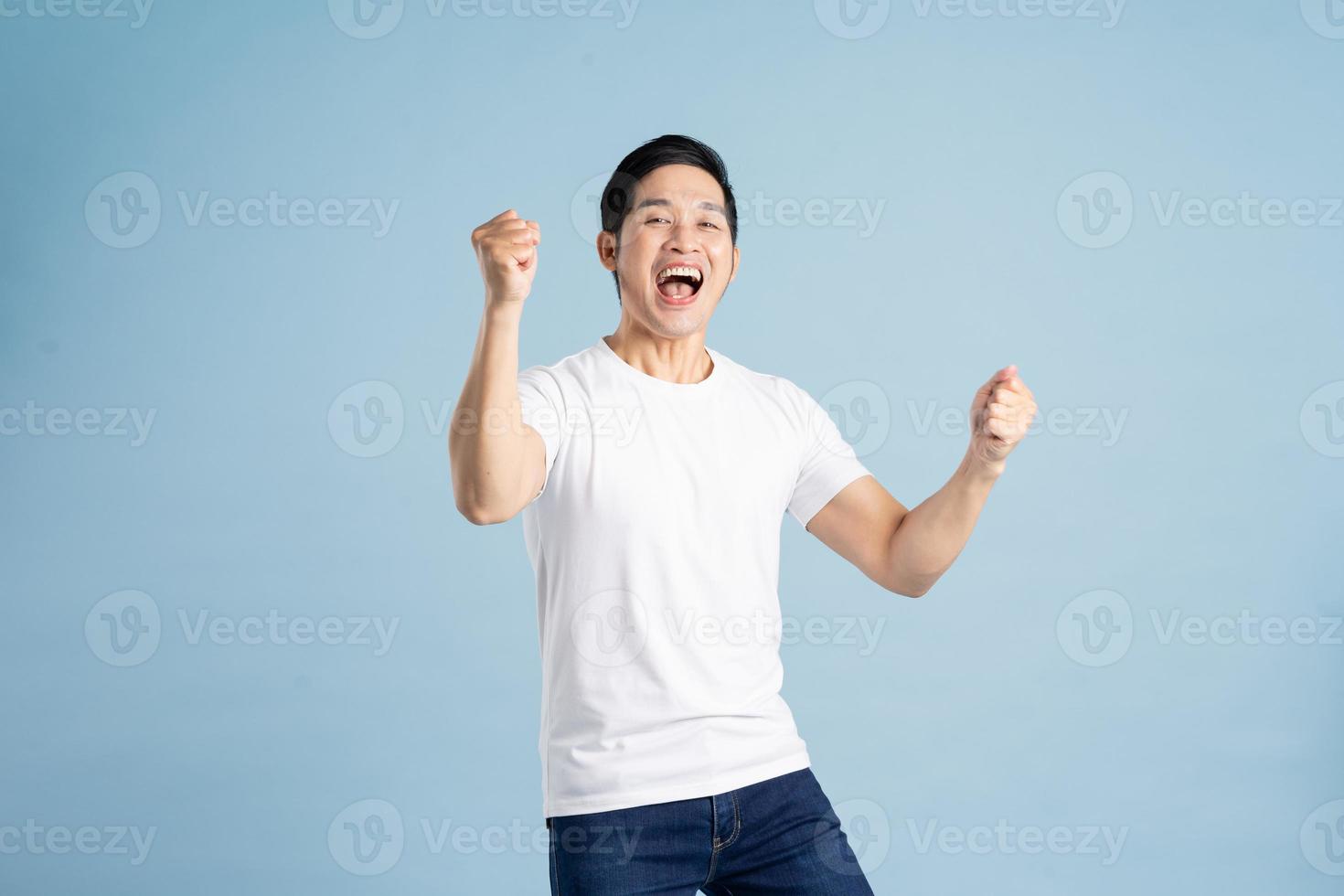 Asian male portrait posing on blue background photo