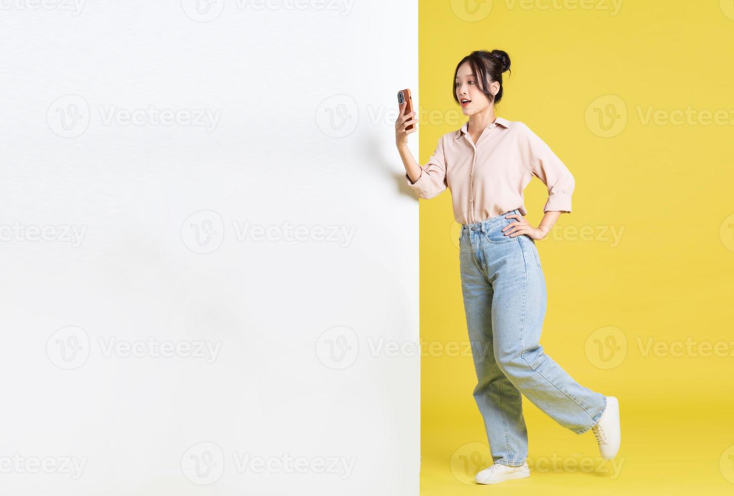 image of Asian girl standing and posing with billboard photo