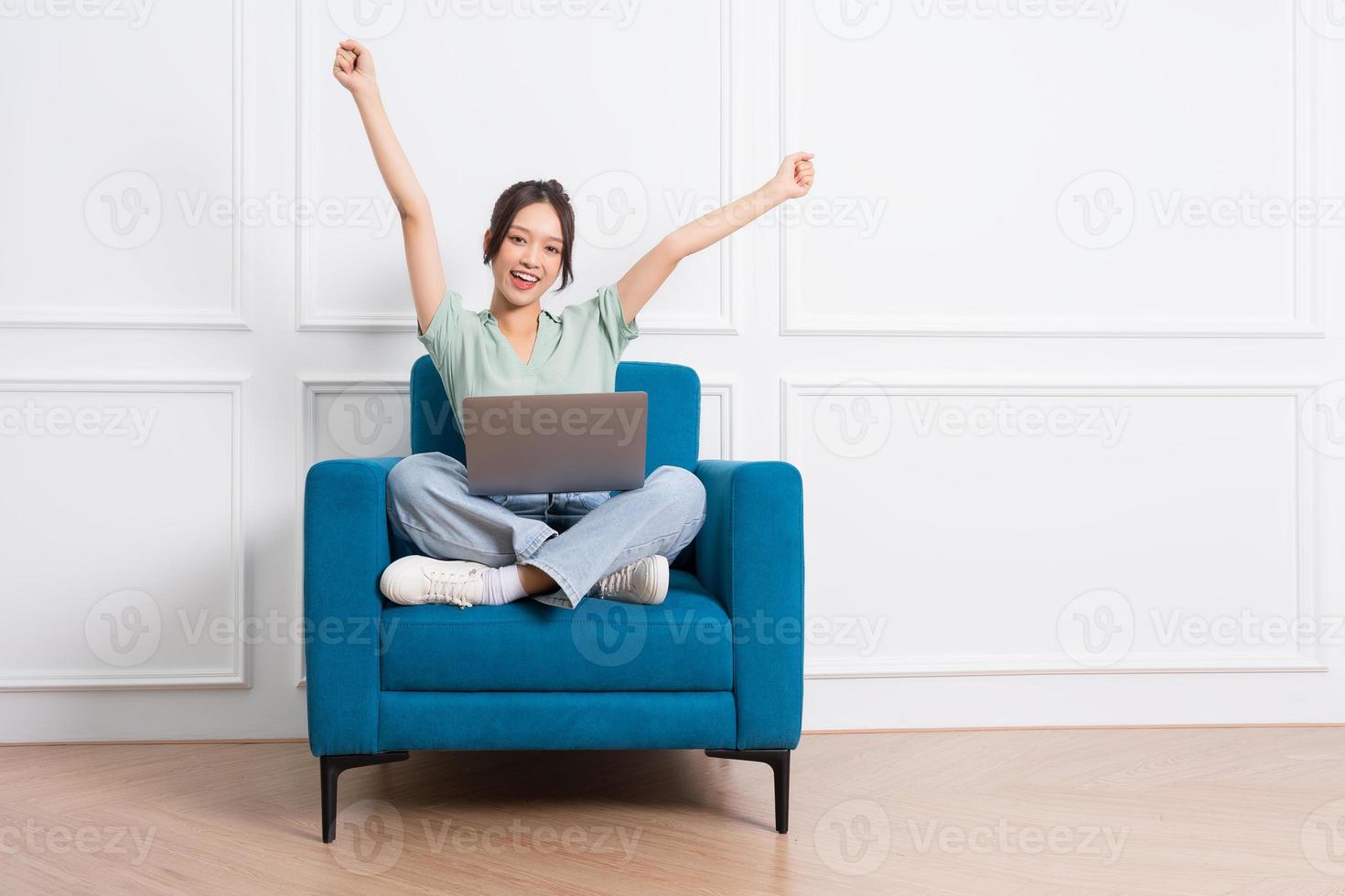 image of young Asian girl sitting on sofa at home photo
