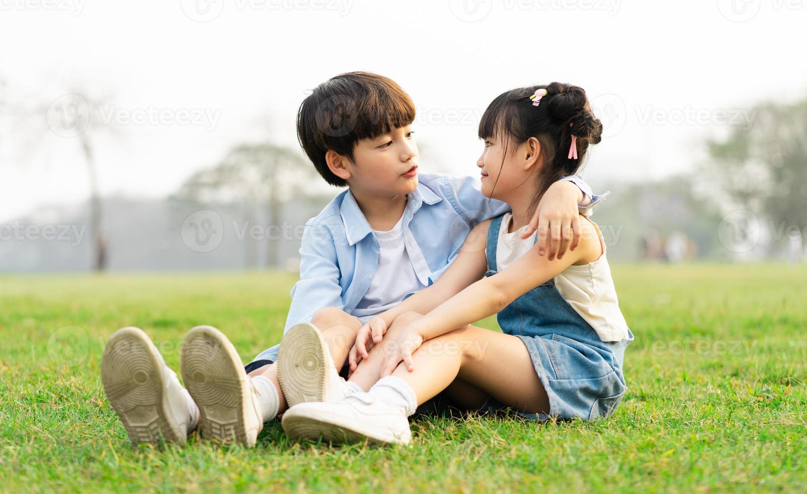 image of brother and sister having fun in the park photo