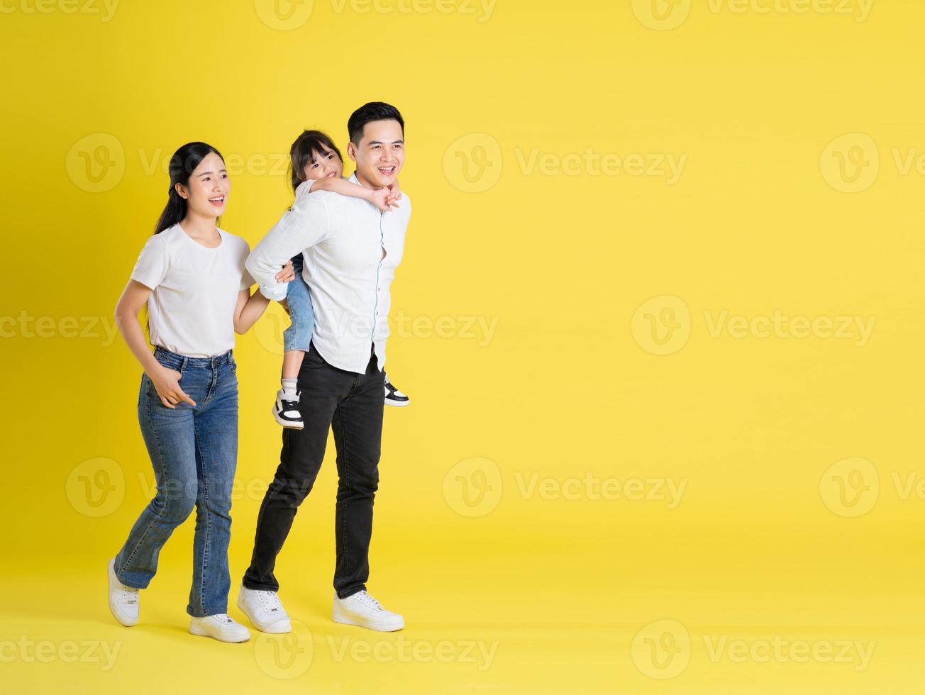 happy asian family image, isolated on yellow background photo