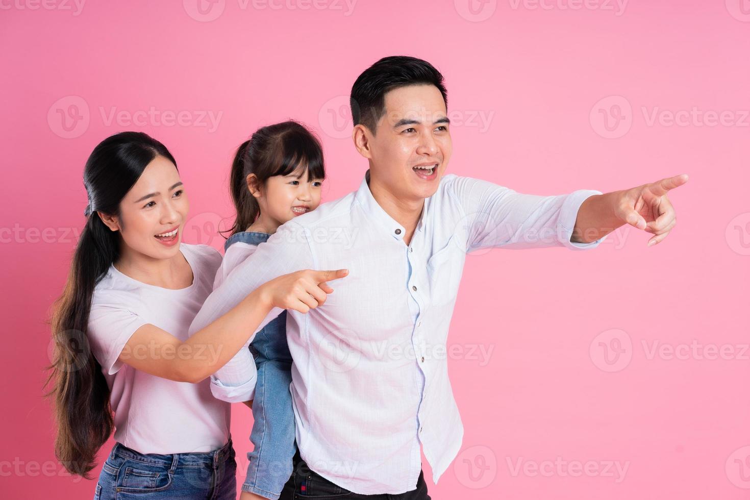 young asian family image isolated on pink background photo