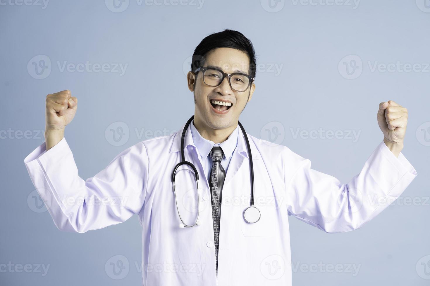 Asian male doctor portrait on blue background photo