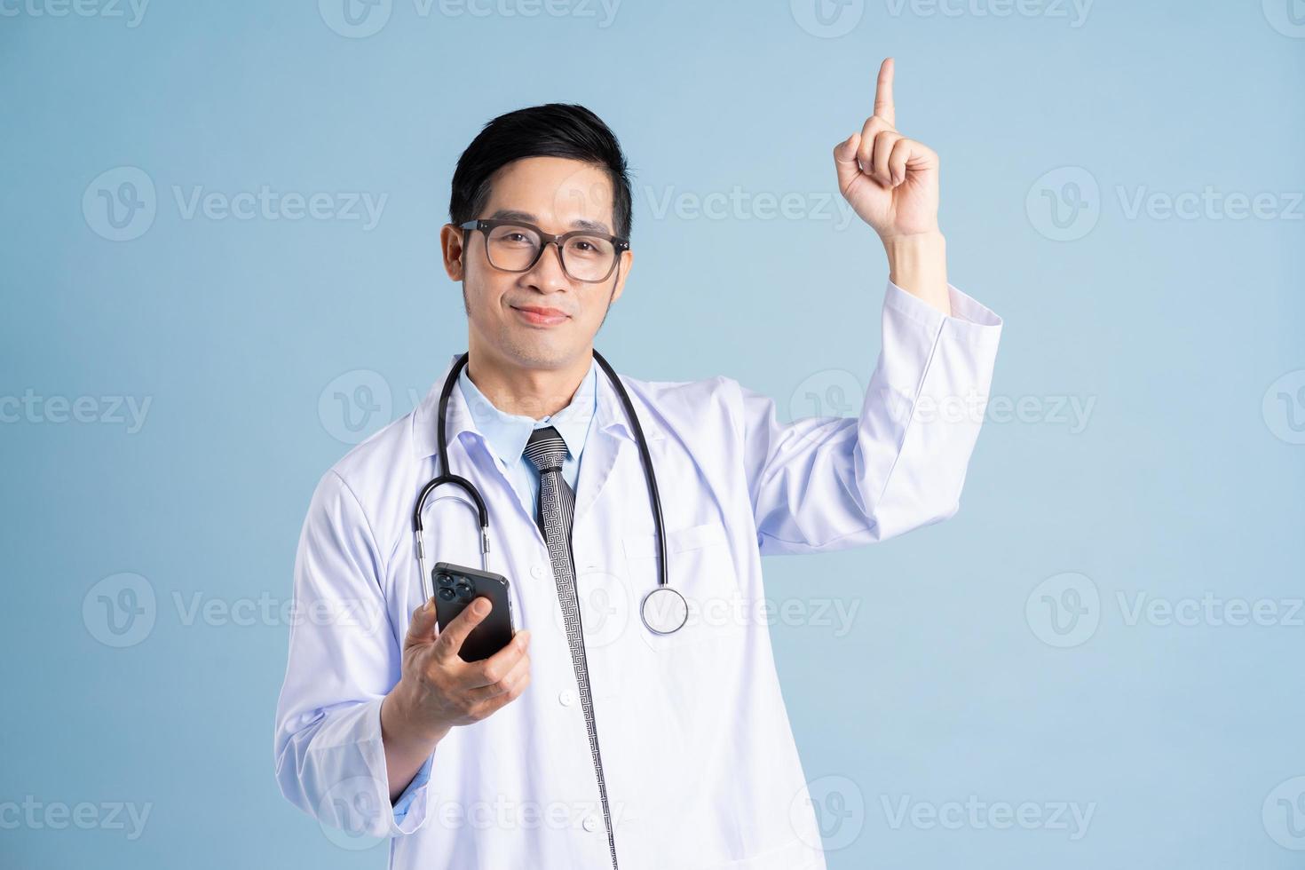 Asian male doctor portrait on blue background photo