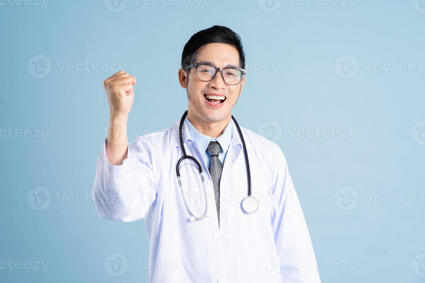 Asian male doctor portrait on blue background photo