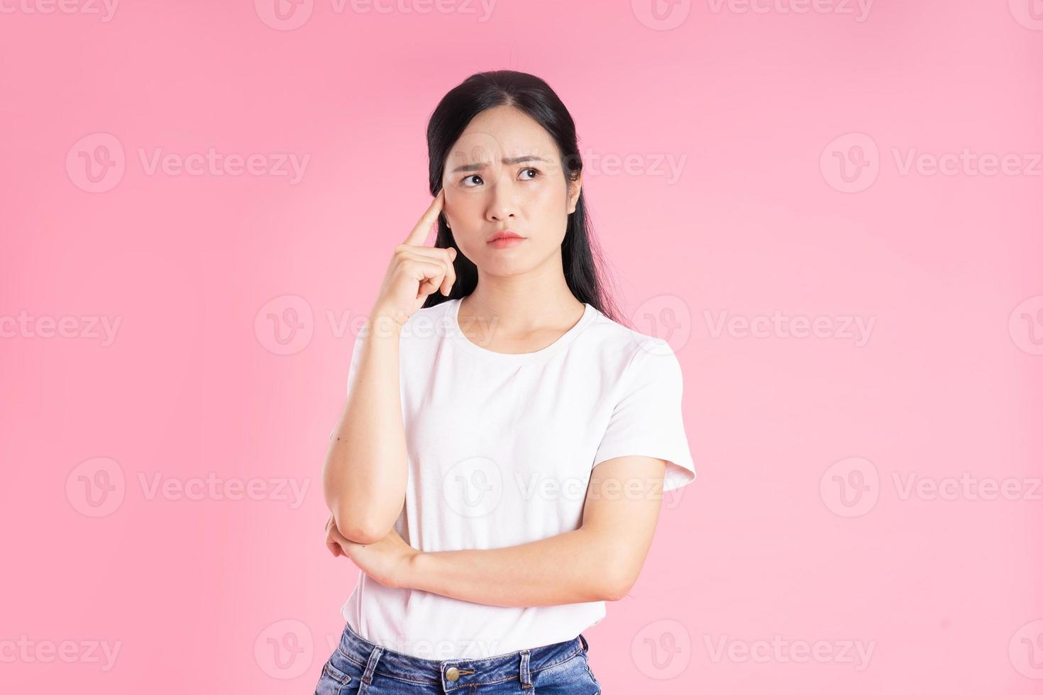 beautiful asian girl portrait, isolated on pink background photo