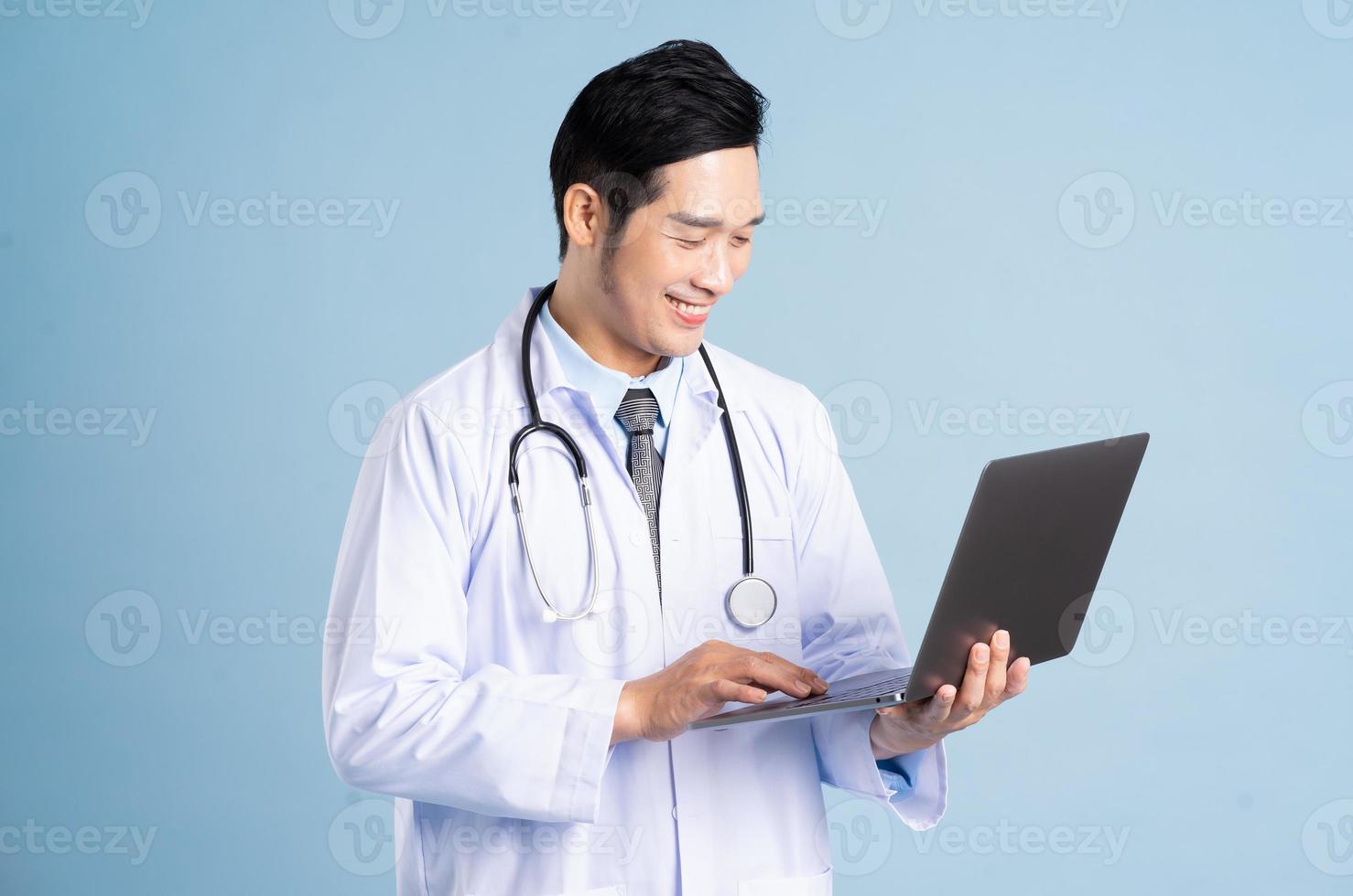 Asian male doctor portrait on blue background photo