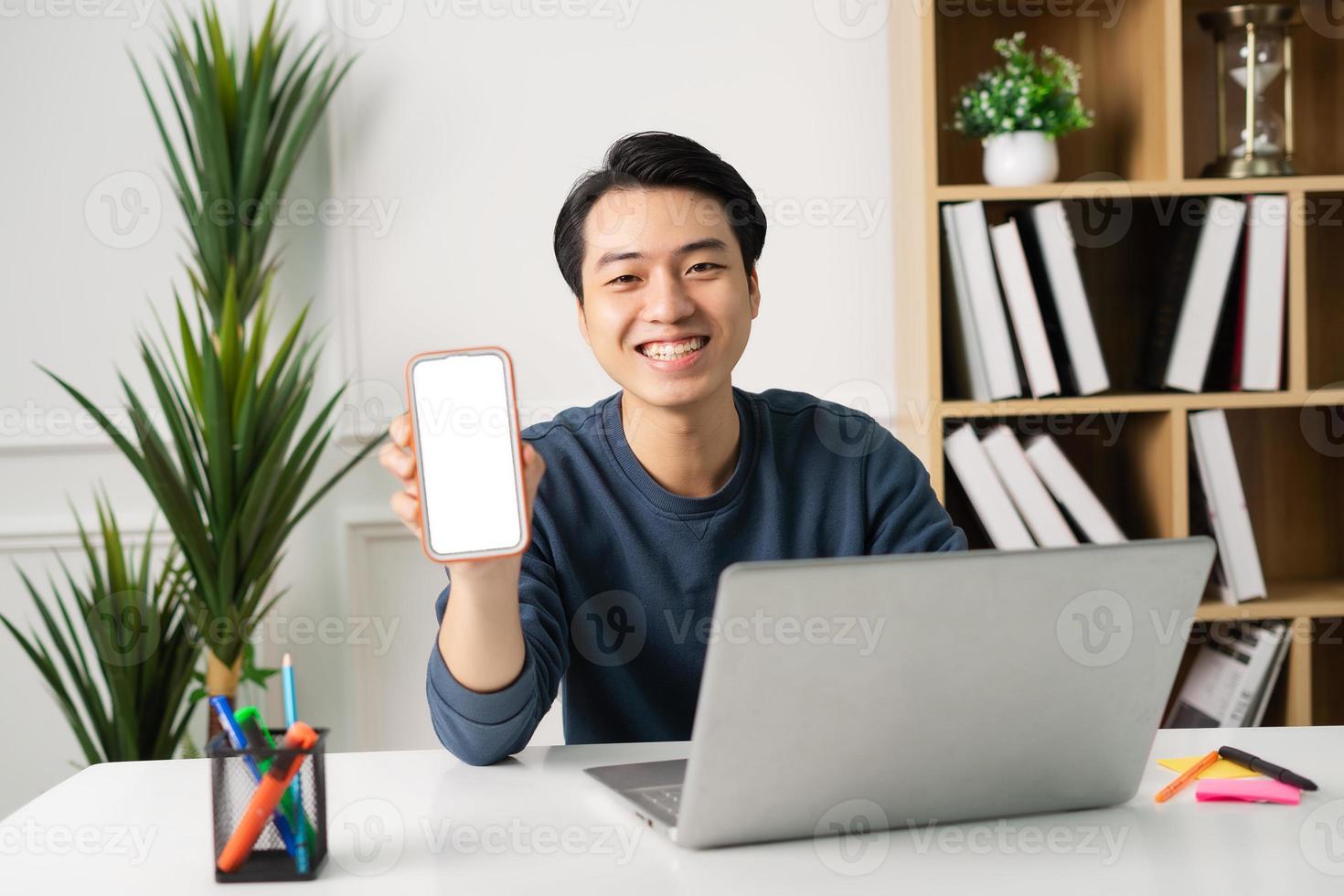 image of Asian man sitting at home working photo