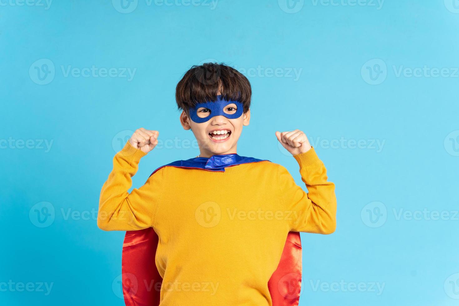 The image of a boy wearing a cape transforms into a hero photo