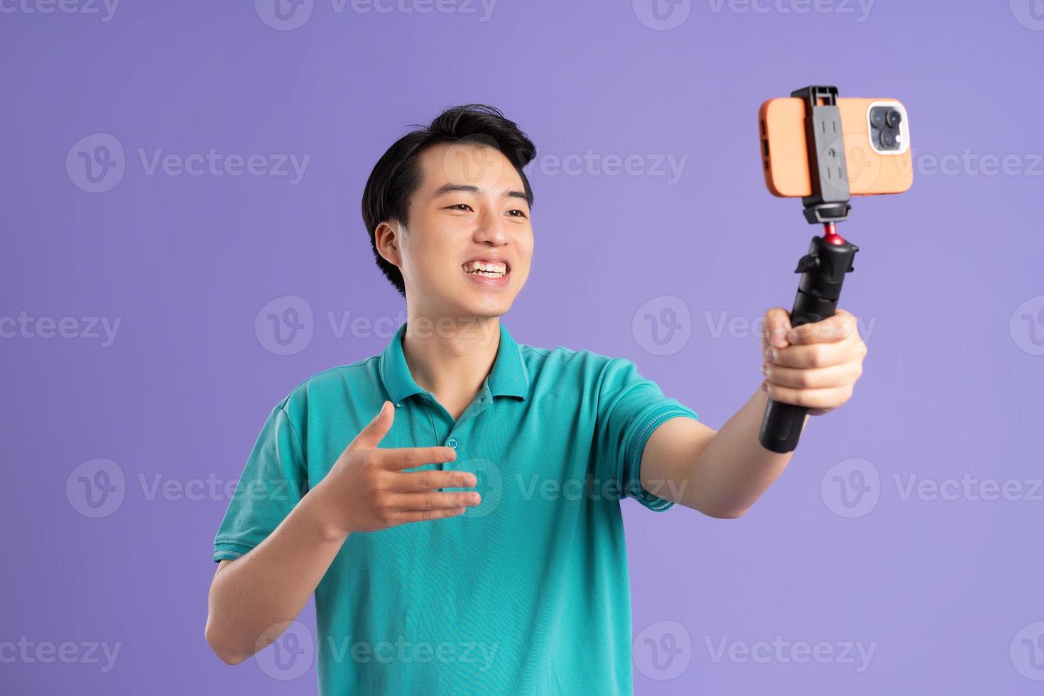 portrait of asian man posing on purple background photo