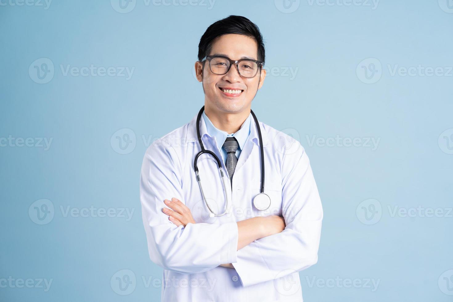 Asian male doctor portrait on blue background photo