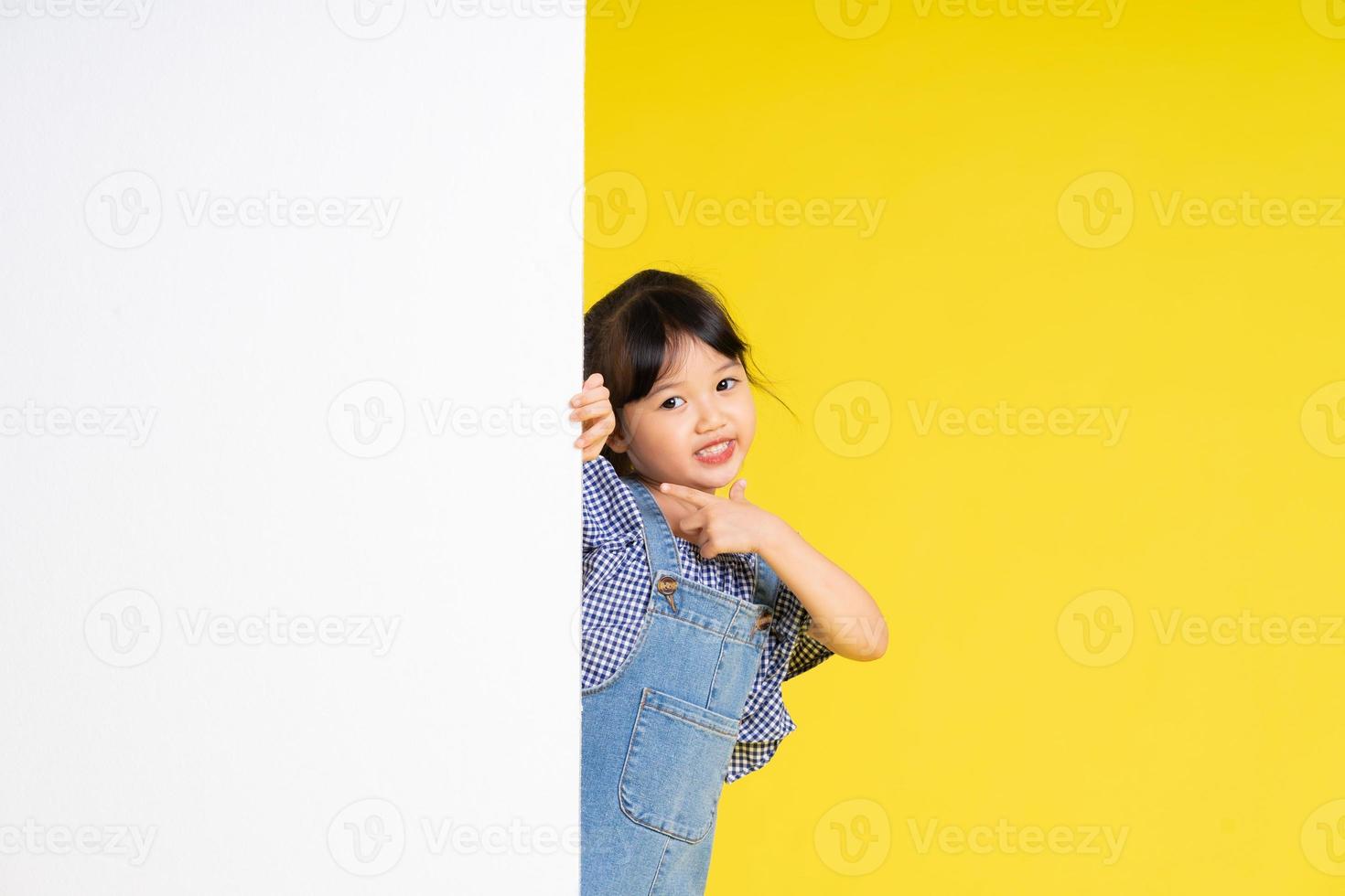 beautiful asian girl portrait, isolated on yellow background photo