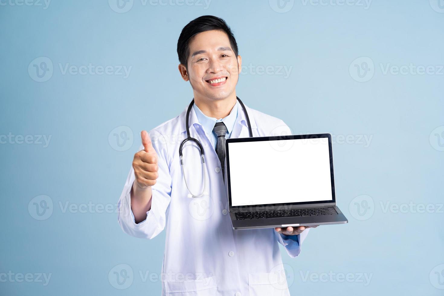 Asian male doctor portrait on blue background photo