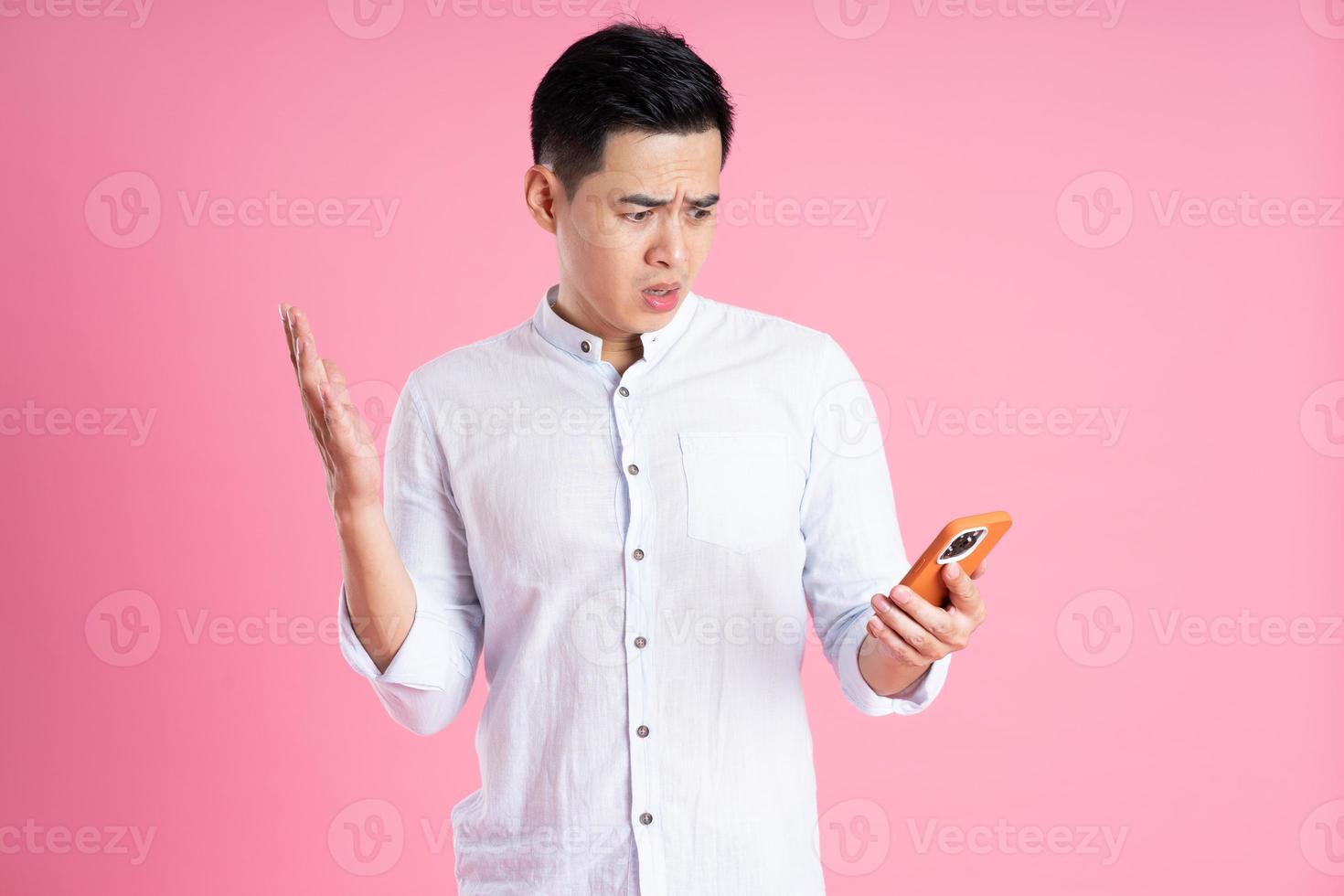 portrait of asian man posing on pink background photo