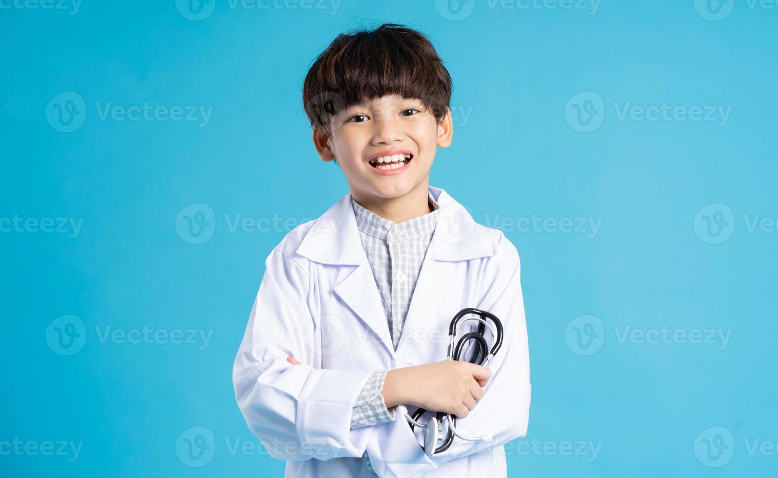 Asian boy portrait posing on blue background photo