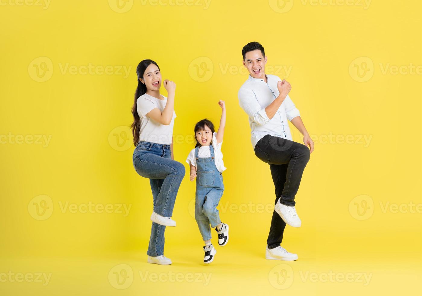 happy asian family image, isolated on yellow background photo