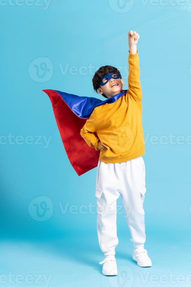 The image of a boy wearing a cape transforms into a hero photo