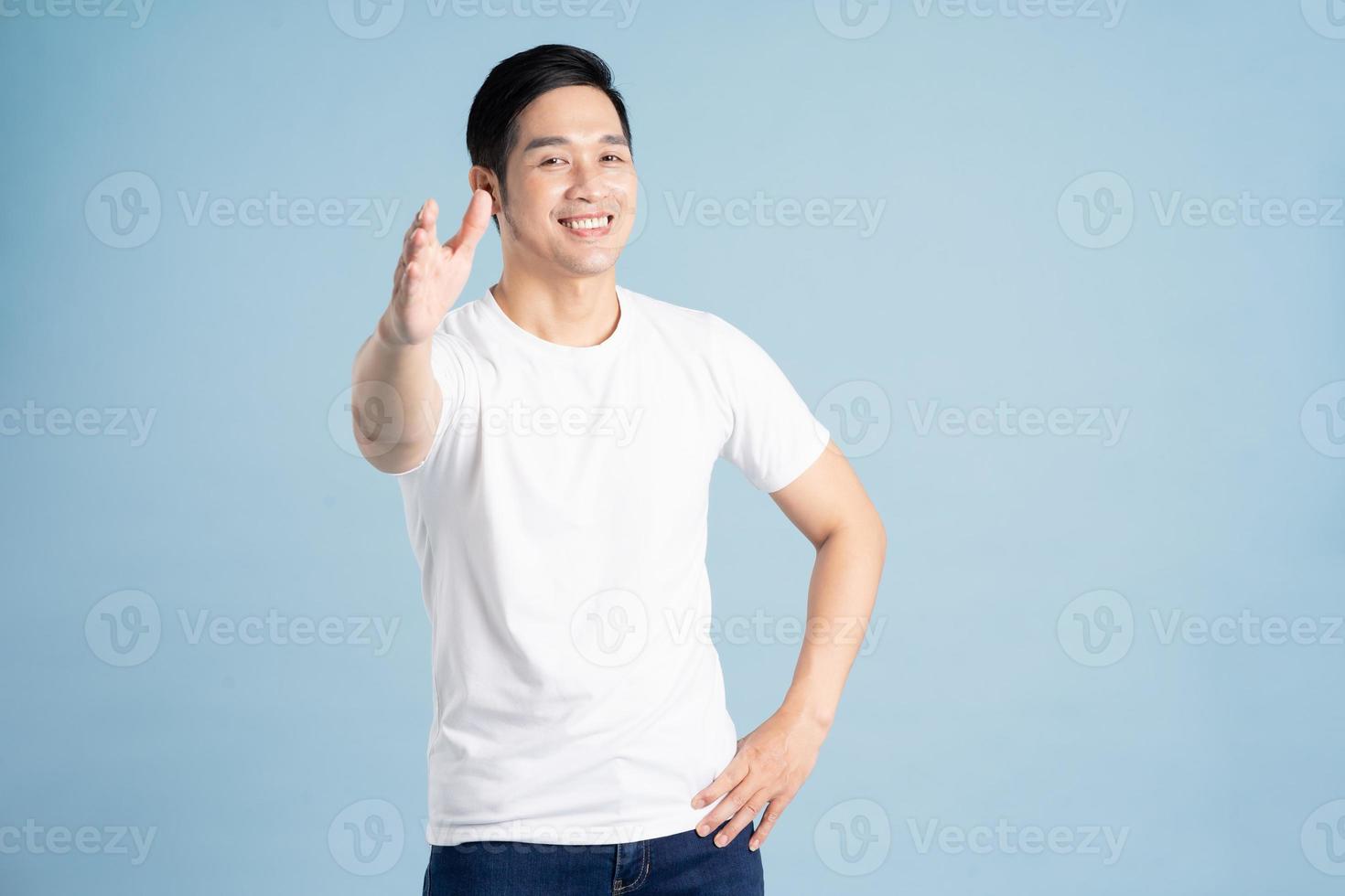 Asian male portrait posing on blue background photo