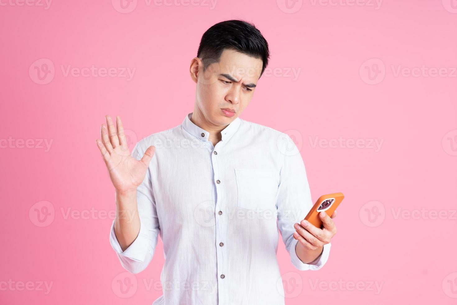 portrait of asian man posing on pink background photo