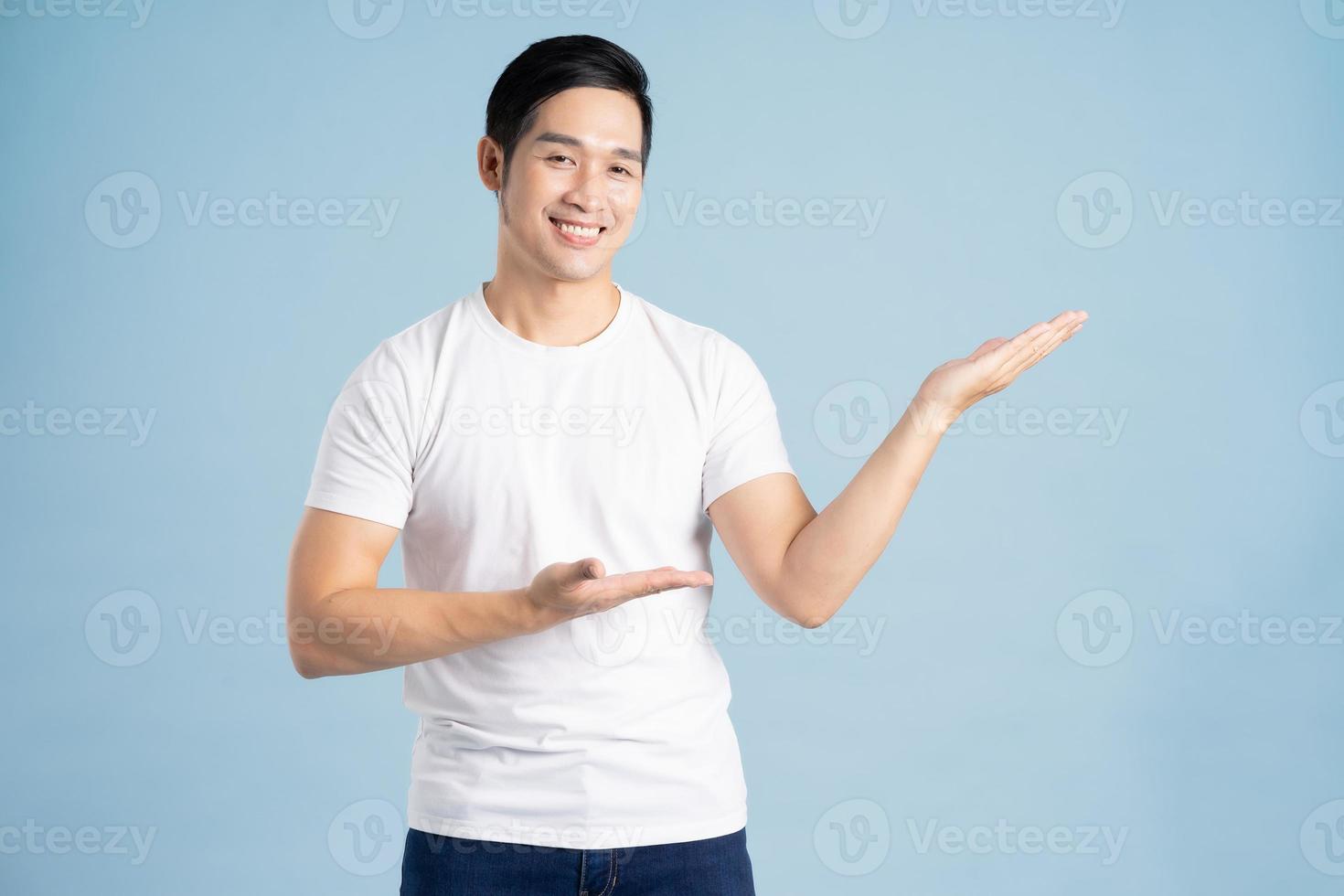 Asian male portrait posing on blue background photo
