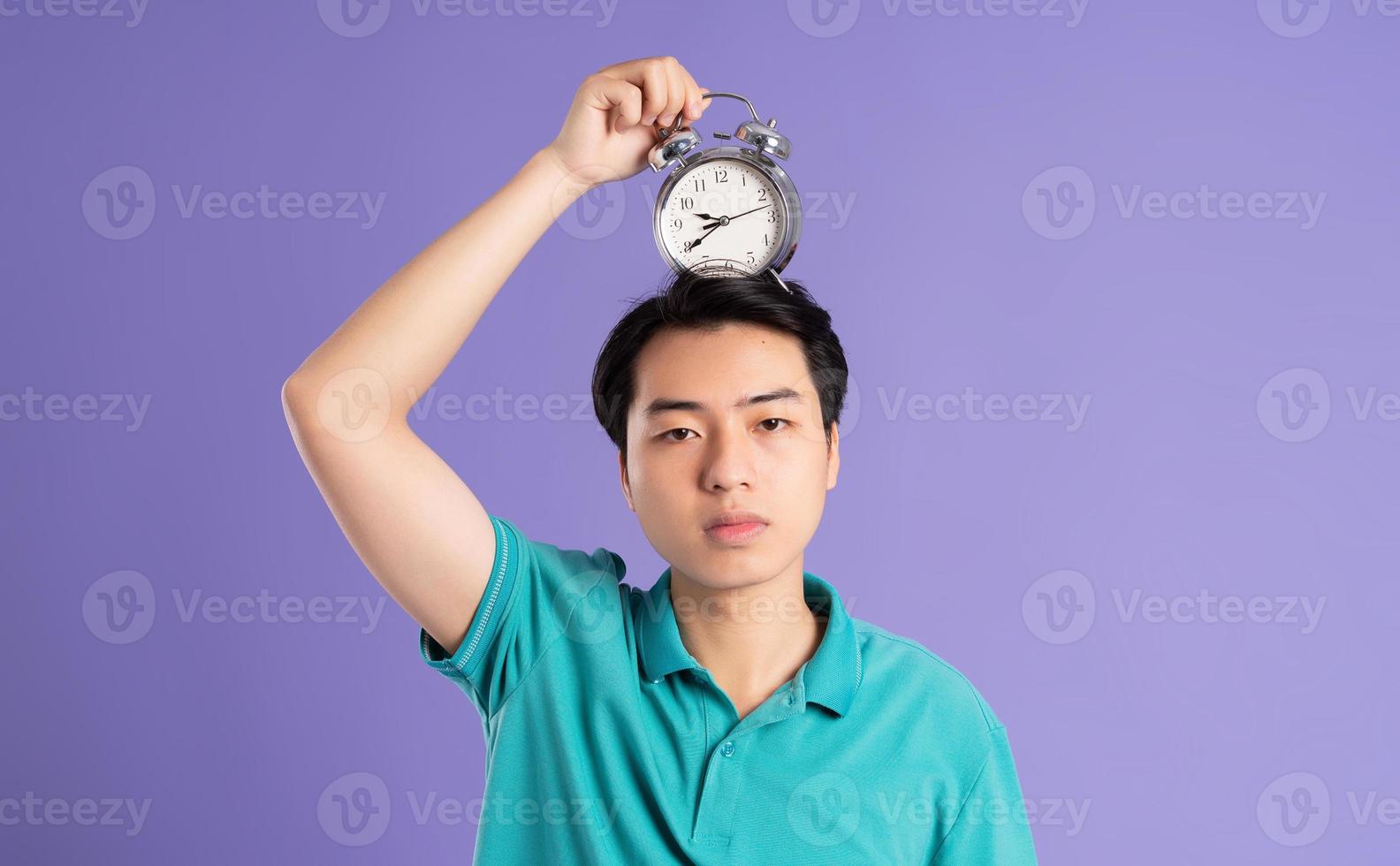 portrait of asian man posing on purple background photo