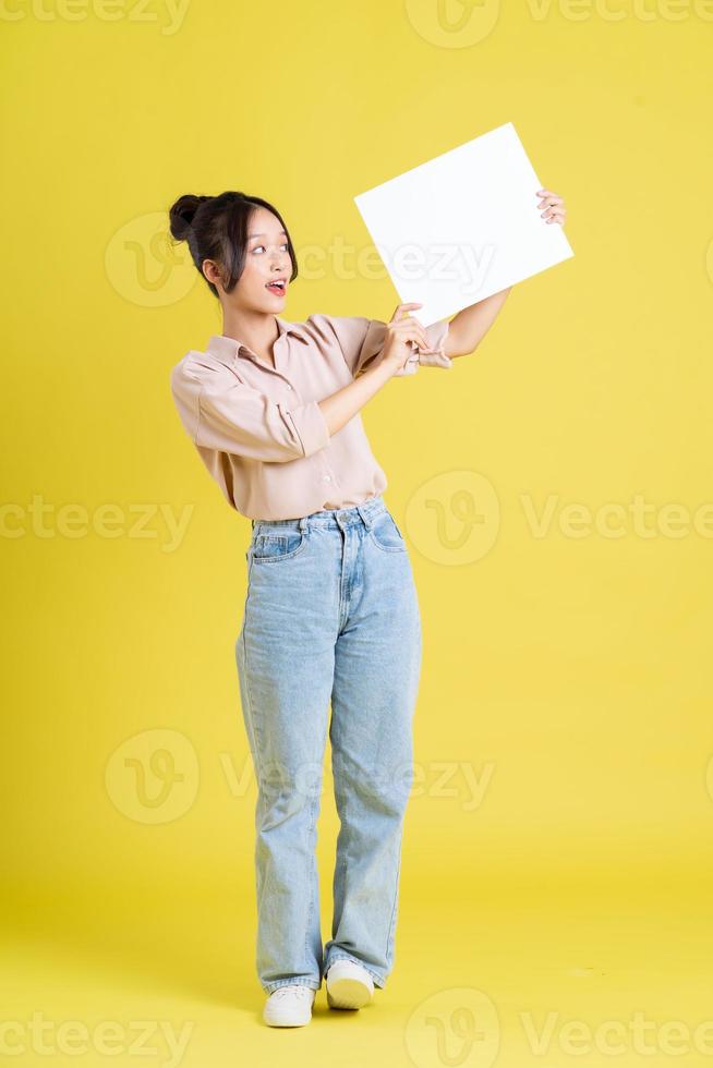 image of a pretty asian girl holding a white billboard photo