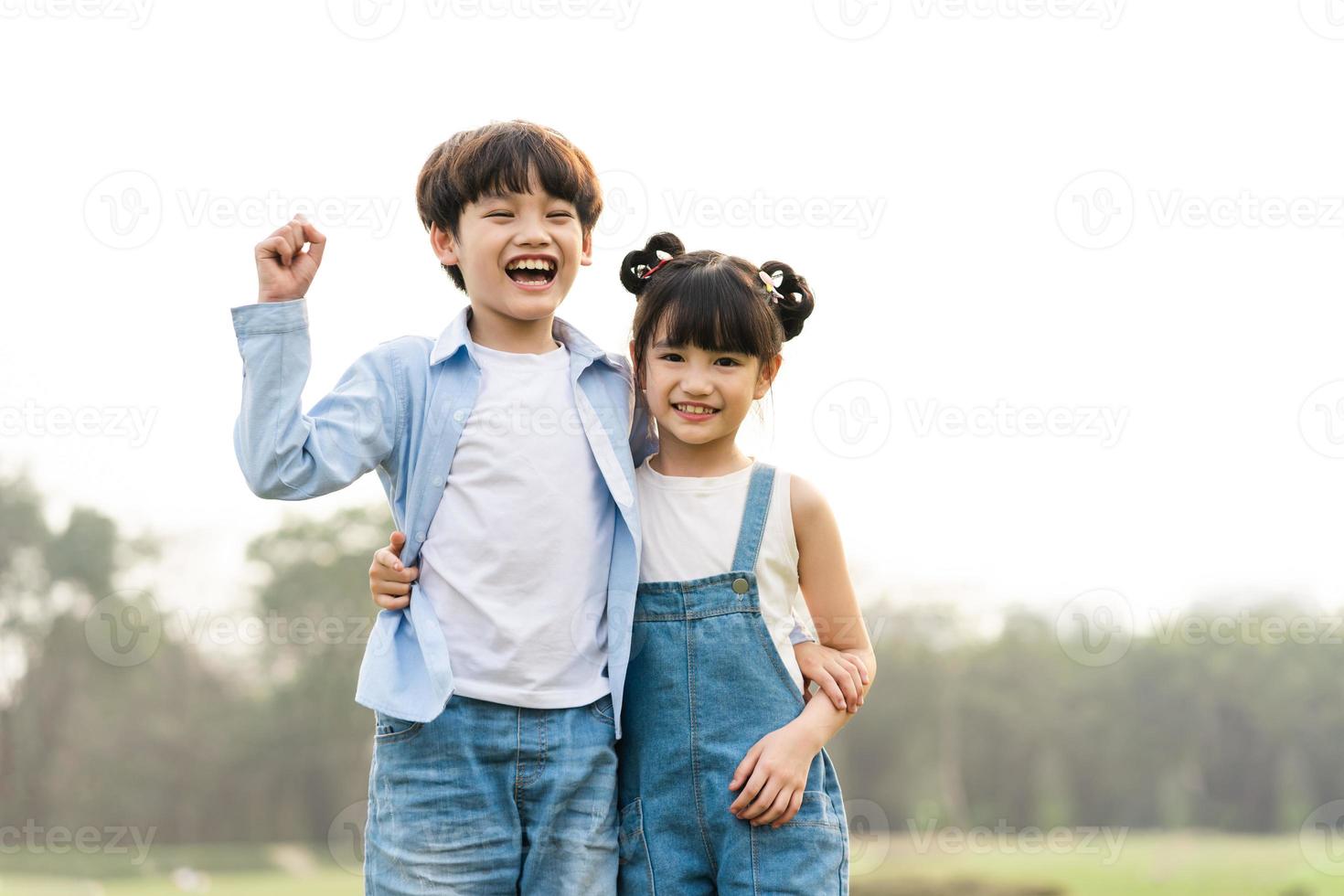 image of brother and sister having fun in the park photo