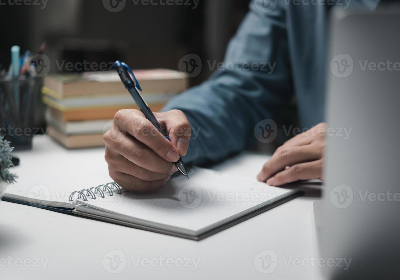 Businessperson reading and writing on book.education studying knowledge development and cognition learning concept. photo