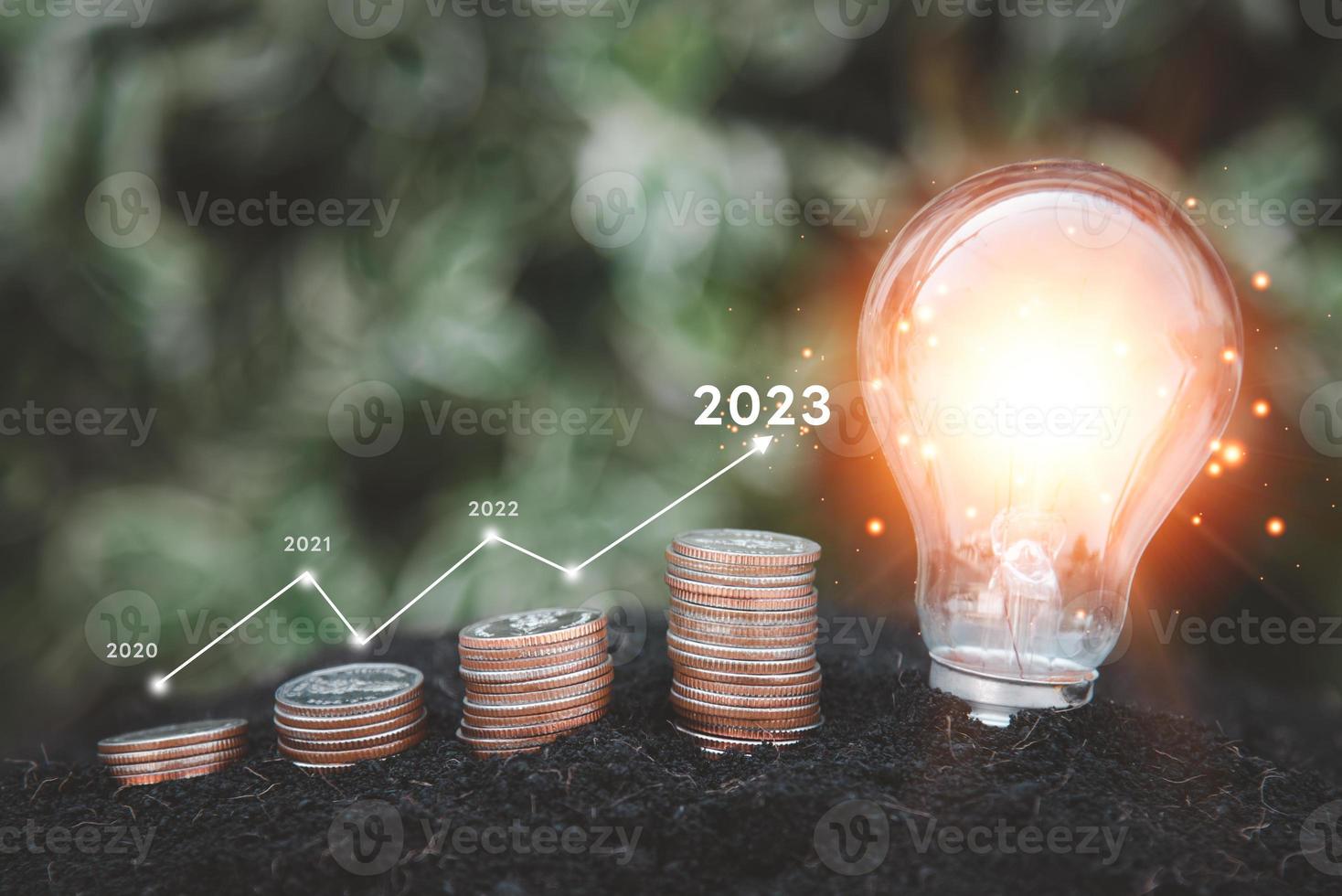 Development to success in year 2023. Energy stock investment and finance saving light bulb innovations and ideas coin stacks. photo