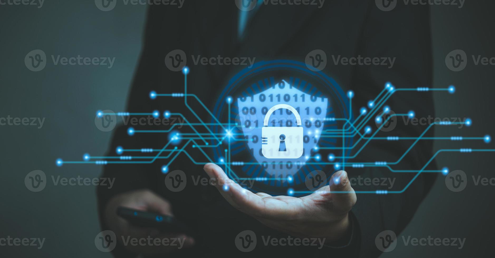 Businessman holding shield protect icon. Cyber security network. Padlock icon and internet technology networking security system. Business data personal information on virtual interface. photo