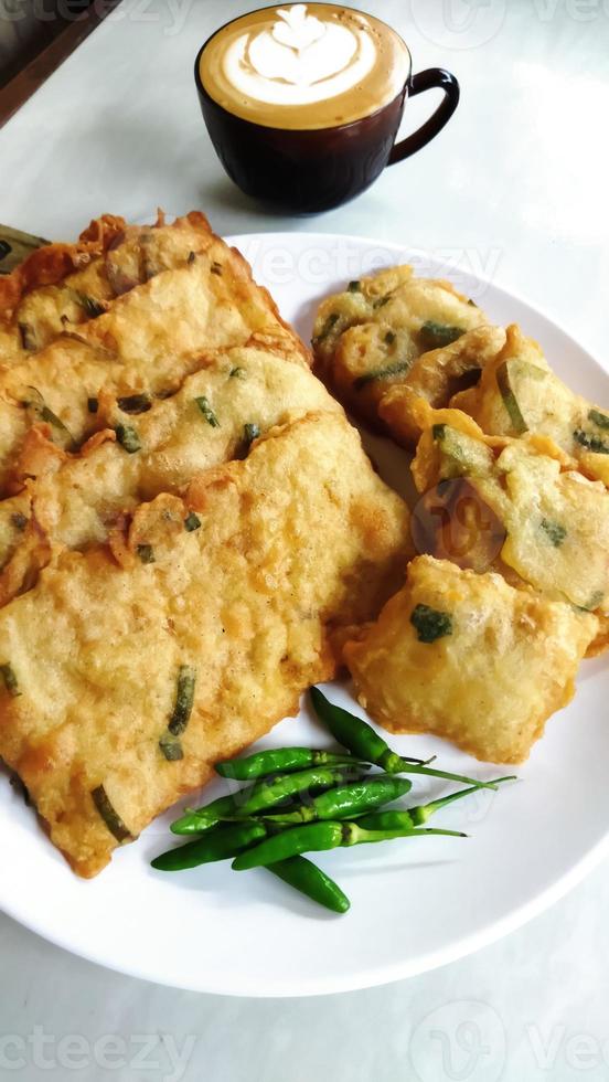 Tempe Mendoan or Indonesian traditional fried tempeh, one of popular street food made from tempeh, deep fried, served with sambal or chili. photo