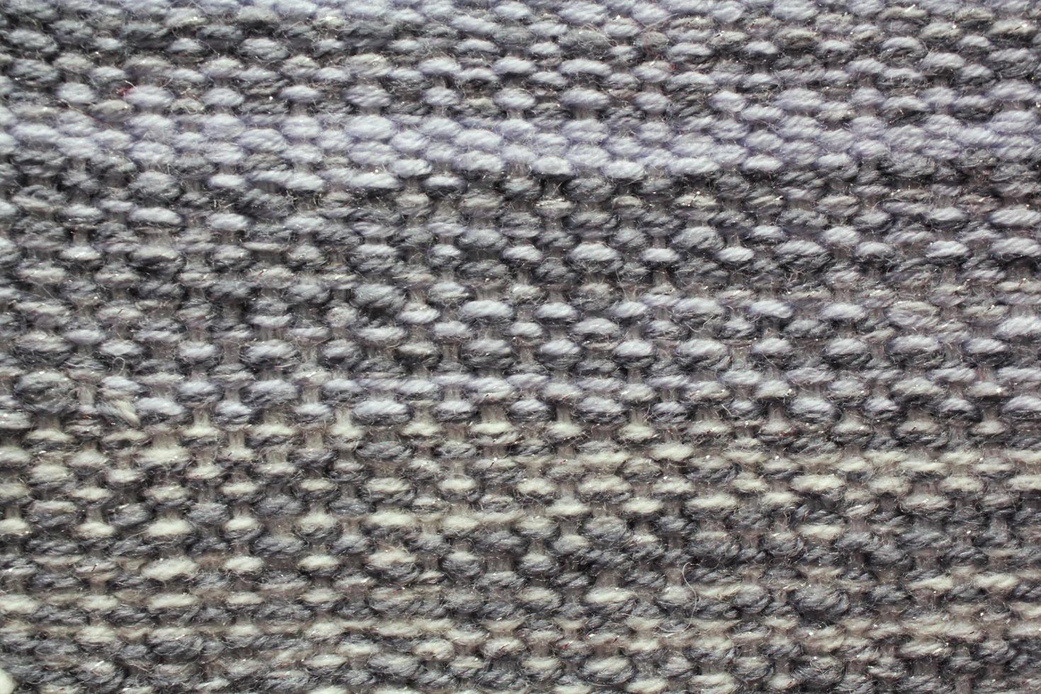 Woven grey wool fabric texture. Hand knitted textile canvas background. Patchwork carpet backdrop. Factory material threads. Abstract design. Close-up, mockup, top view photo