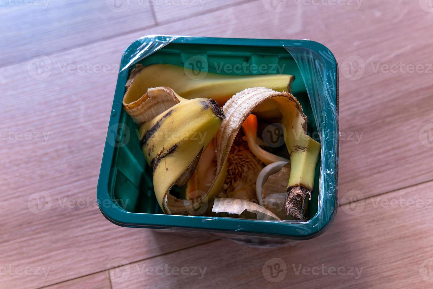 plastic container with fruit and vegetable waste photo