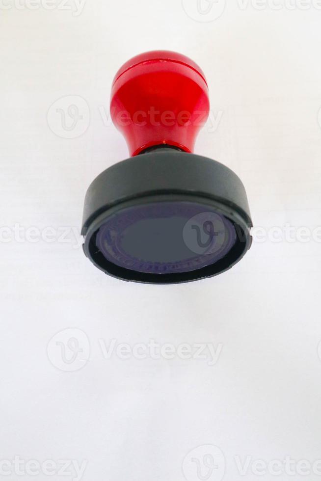 Stamp, modern Stamp, Red Handle Rubber Stamp Top View Isolated on White Background. photo