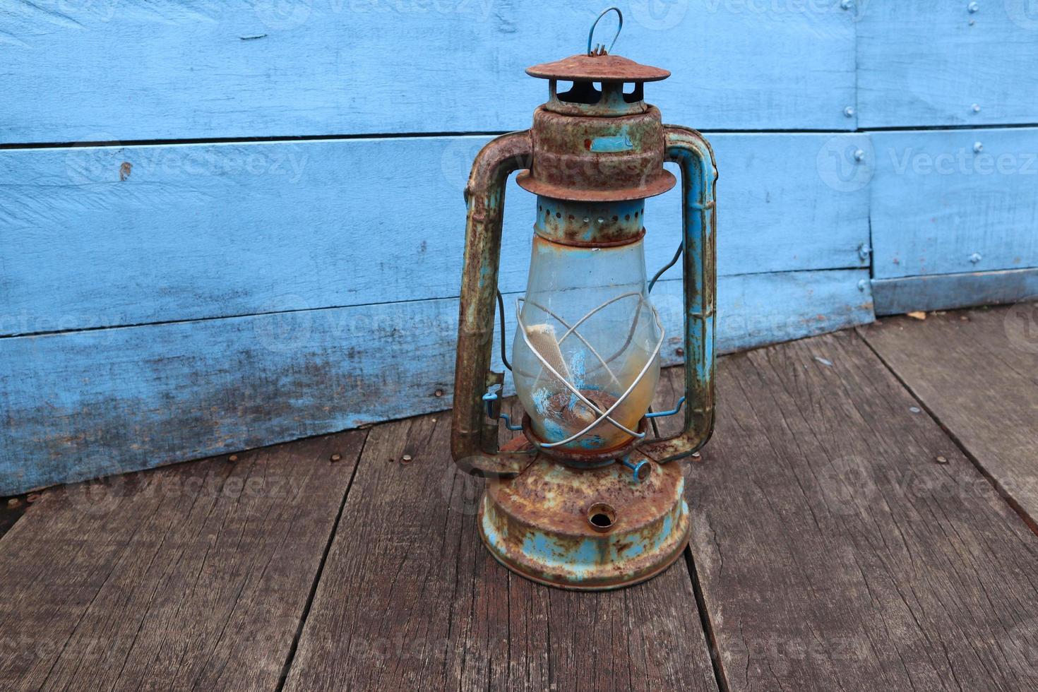 antique petromak lamp or teplok which still uses kerosene fuel on wood background photo